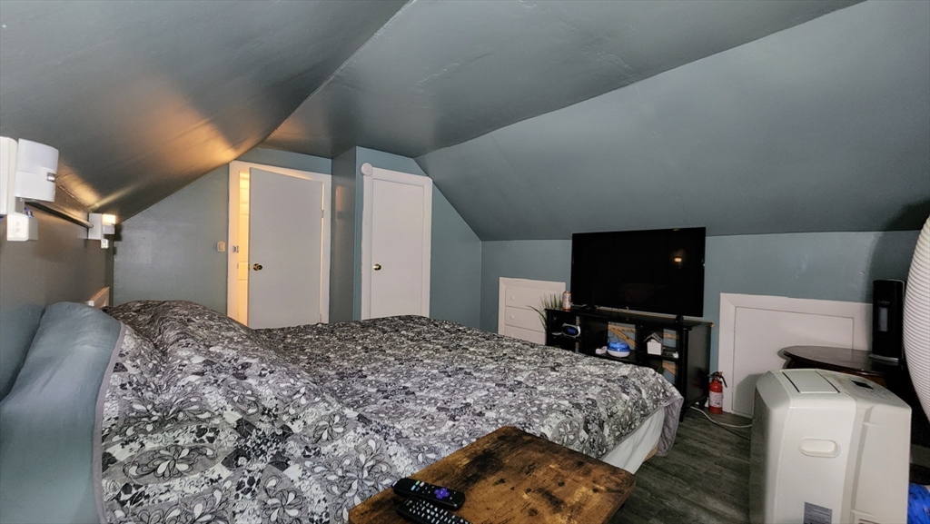 4 Fuller Road Attleboro, MA 02703 - Photo 9 of 16 a bedroom with a bed and a flat screen tv