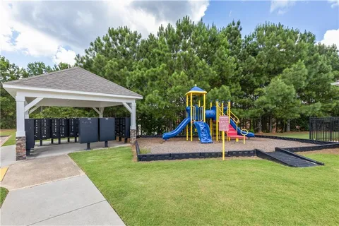 a view of a house with backyard and a slide