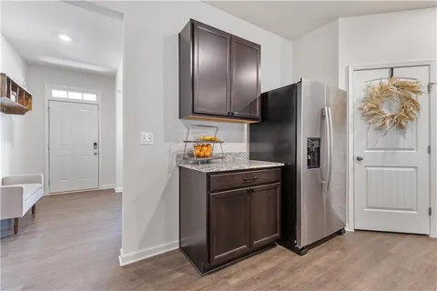 a kitchen with stainless steel appliances granite countertop a refrigerator and a stove