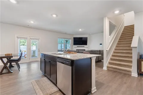 a kitchen with a stove and a wooden floor