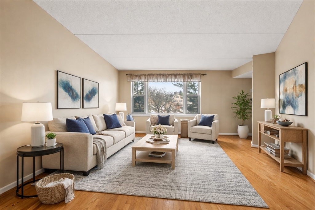 155 George Washington Boulevard, Unit 210 Hull, MA 02045 - Photo 16 of 42 a living room with furniture and a large window