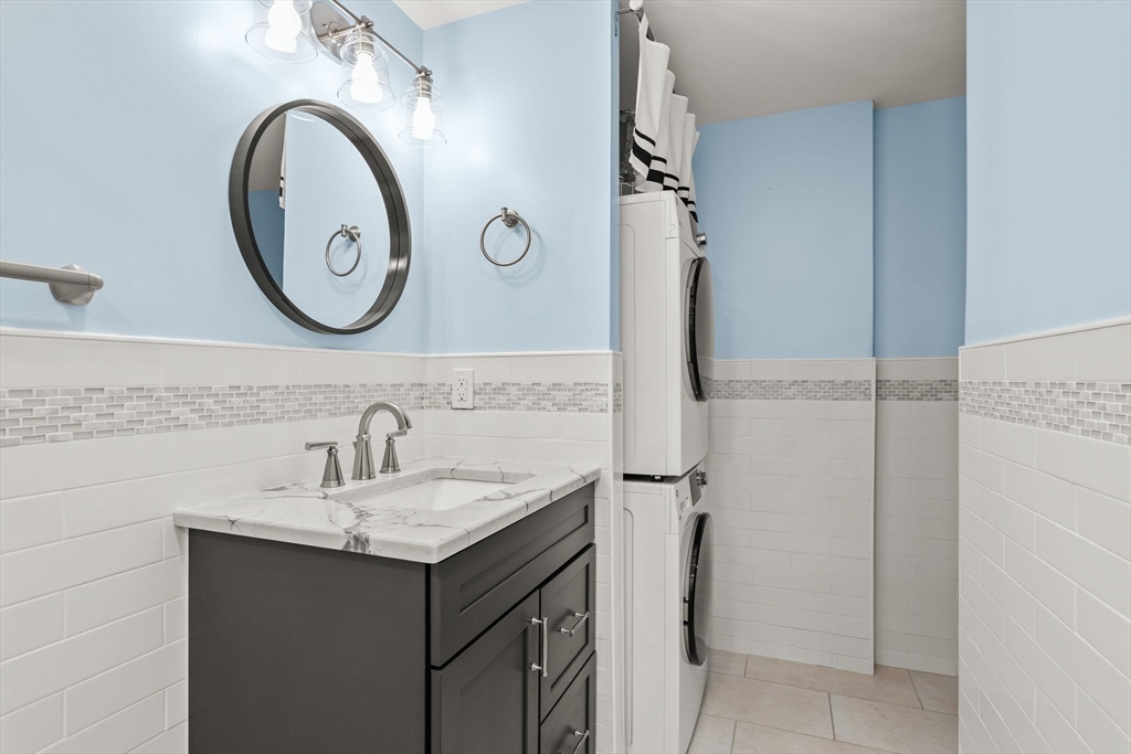 155 George Washington Boulevard, Unit 210 Hull, MA 02045 - Photo 20 of 42 a bathroom with a sink and a mirror