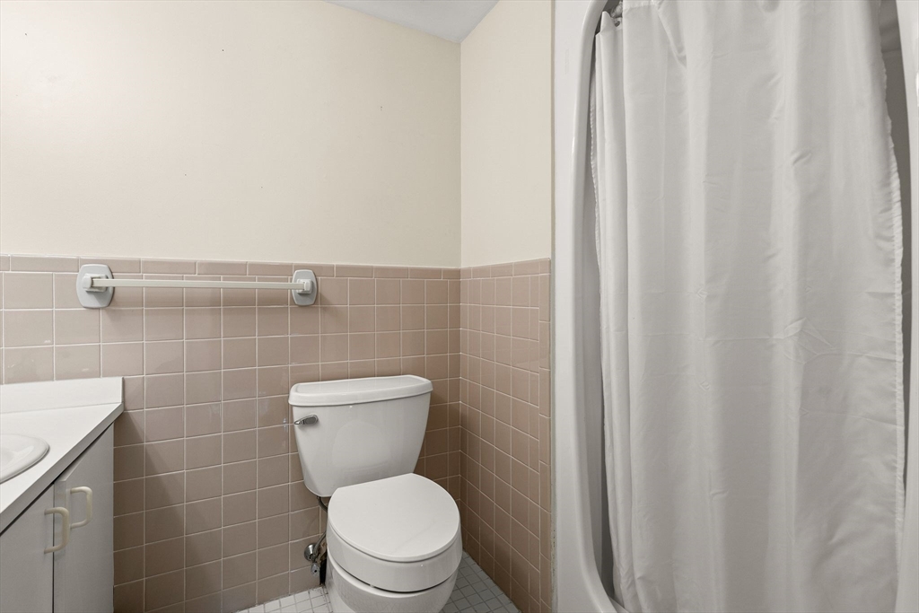 155 George Washington Boulevard, Unit 210 Hull, MA 02045 - Photo 29 of 42 a bathroom with a toilet and a shower