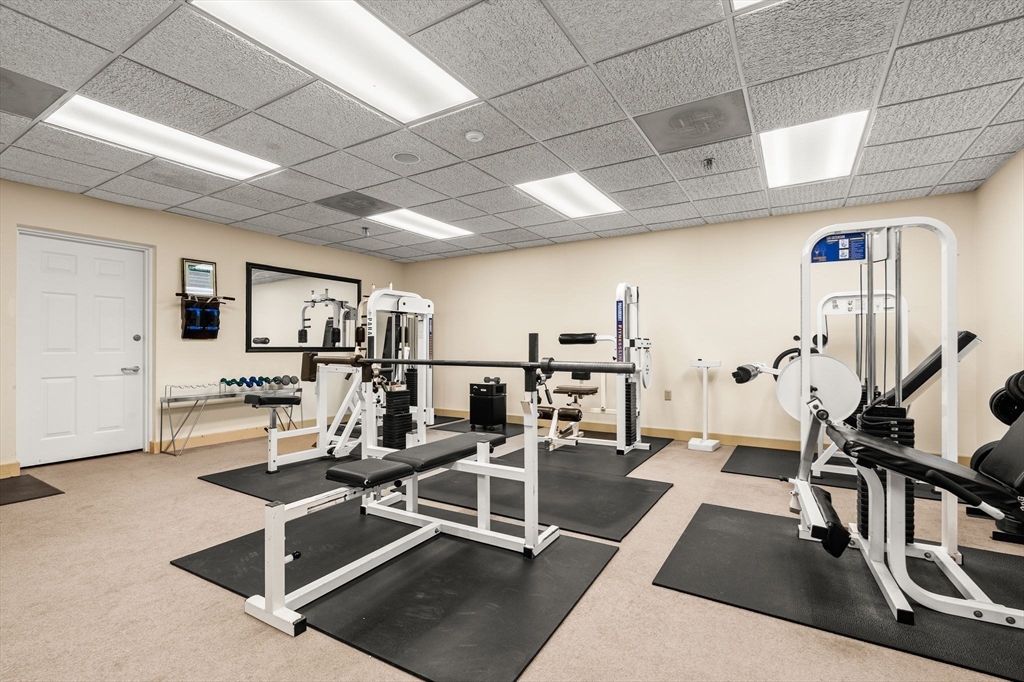 155 George Washington Boulevard, Unit 210 Hull, MA 02045 - Photo 37 of 42 a room with gym equipment and view of living room