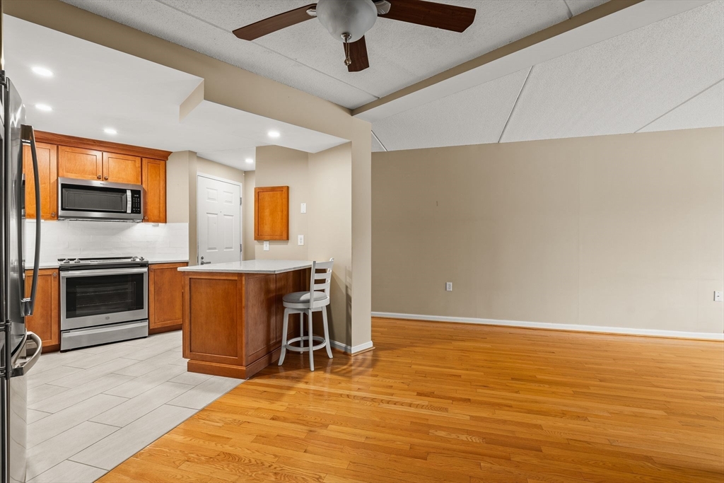 155 George Washington Boulevard, Unit 210 Hull, MA 02045 - Photo 9 of 42 a view of kitchen with furniture and a ceiling fan