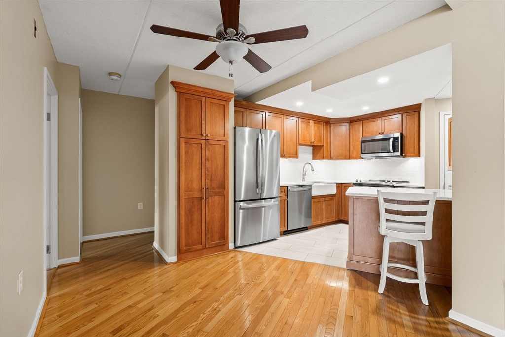 155 George Washington Boulevard, Unit 210 Hull, MA 02045 - Photo 10 of 42 a kitchen with stainless steel appliances a refrigerator and microwave
