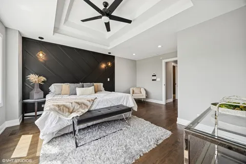 a bed room with a bed and a ceiling fan