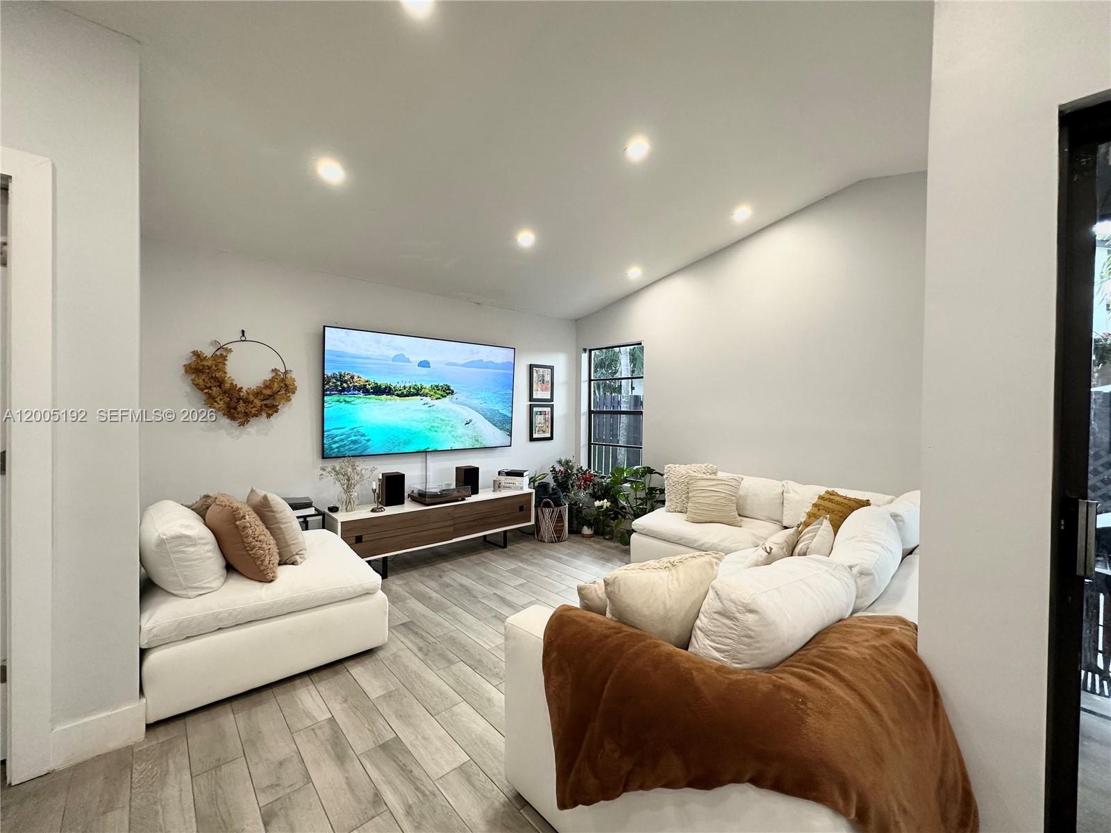 4840 Southwest 149th Court, Unit 16F Miami, FL 33185 - Photo 13 of 33 a living room with furniture and a flat screen tv