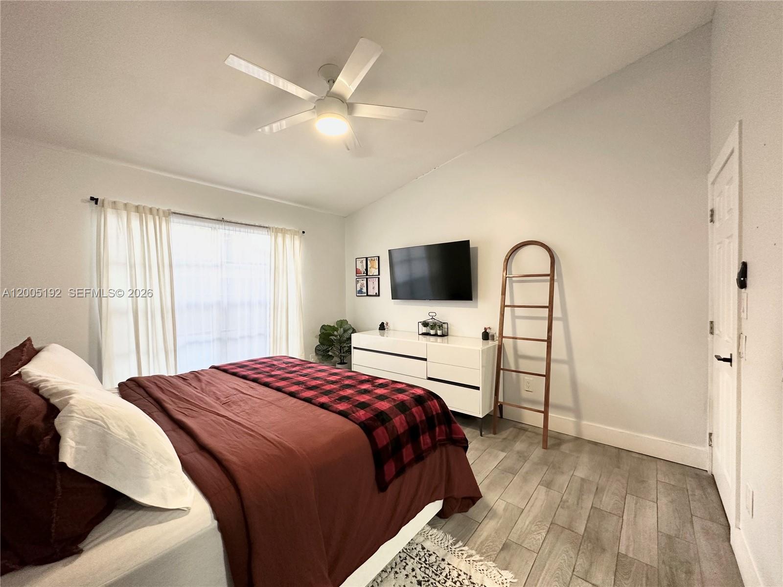 4840 Southwest 149th Court, Unit 16F Miami, FL 33185 - Photo 16 of 33 a bedroom with a bed and a flat screen tv