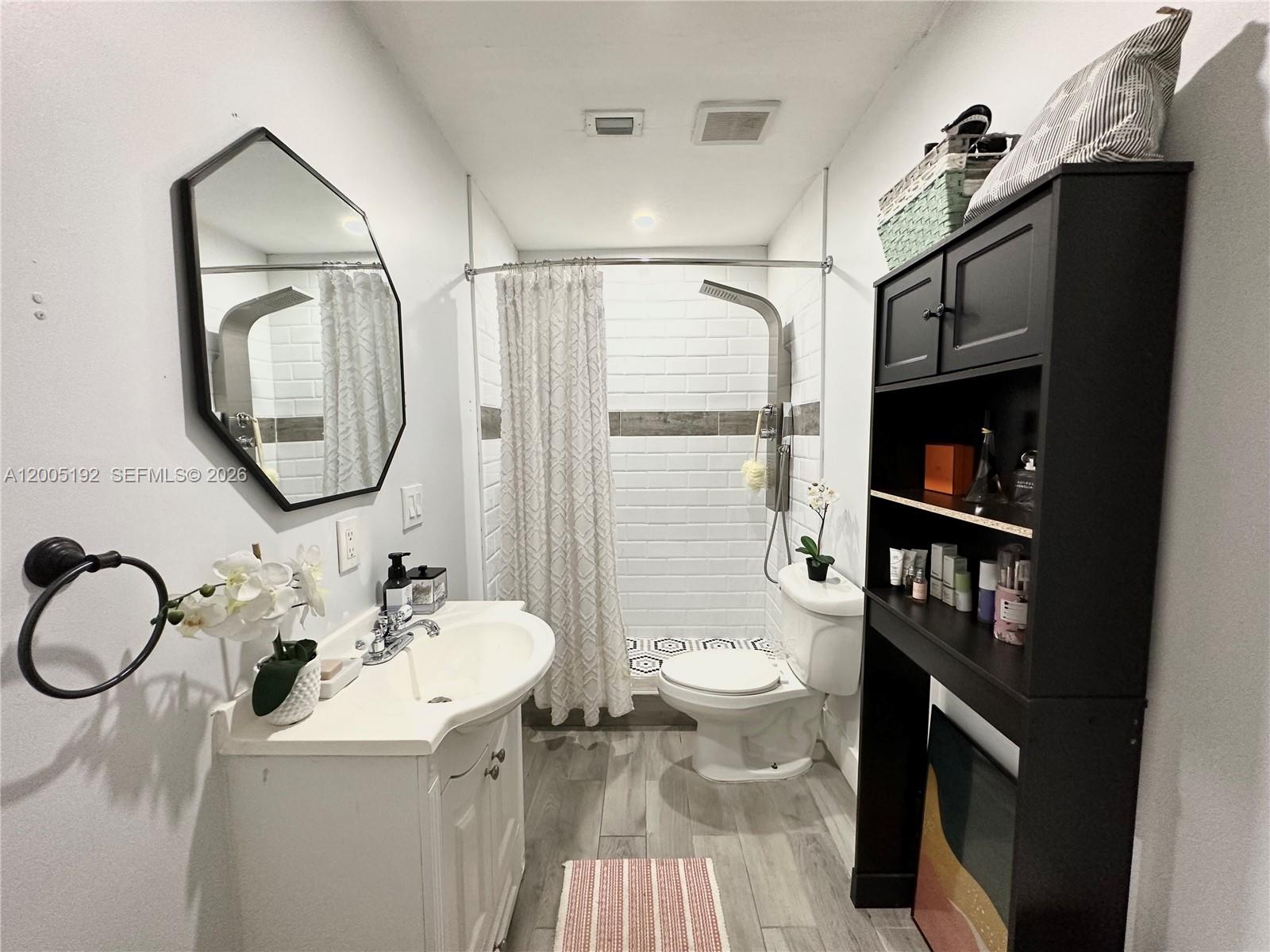 4840 Southwest 149th Court, Unit 16F Miami, FL 33185 - Photo 18 of 33 a bathroom with a sink a toilet and a mirror