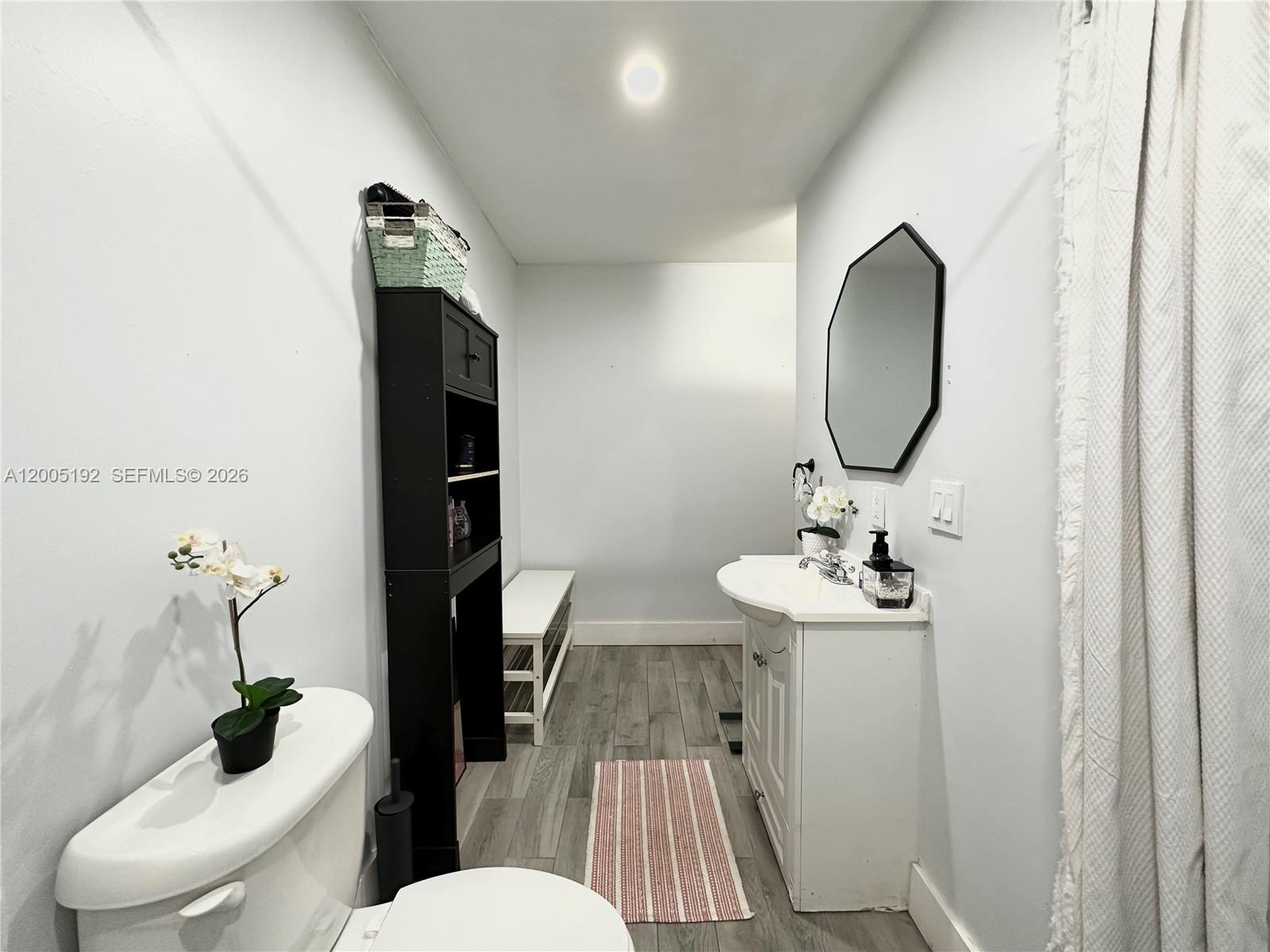 4840 Southwest 149th Court, Unit 16F Miami, FL 33185 - Photo 19 of 33 a bathroom with a sink toilet and mirror
