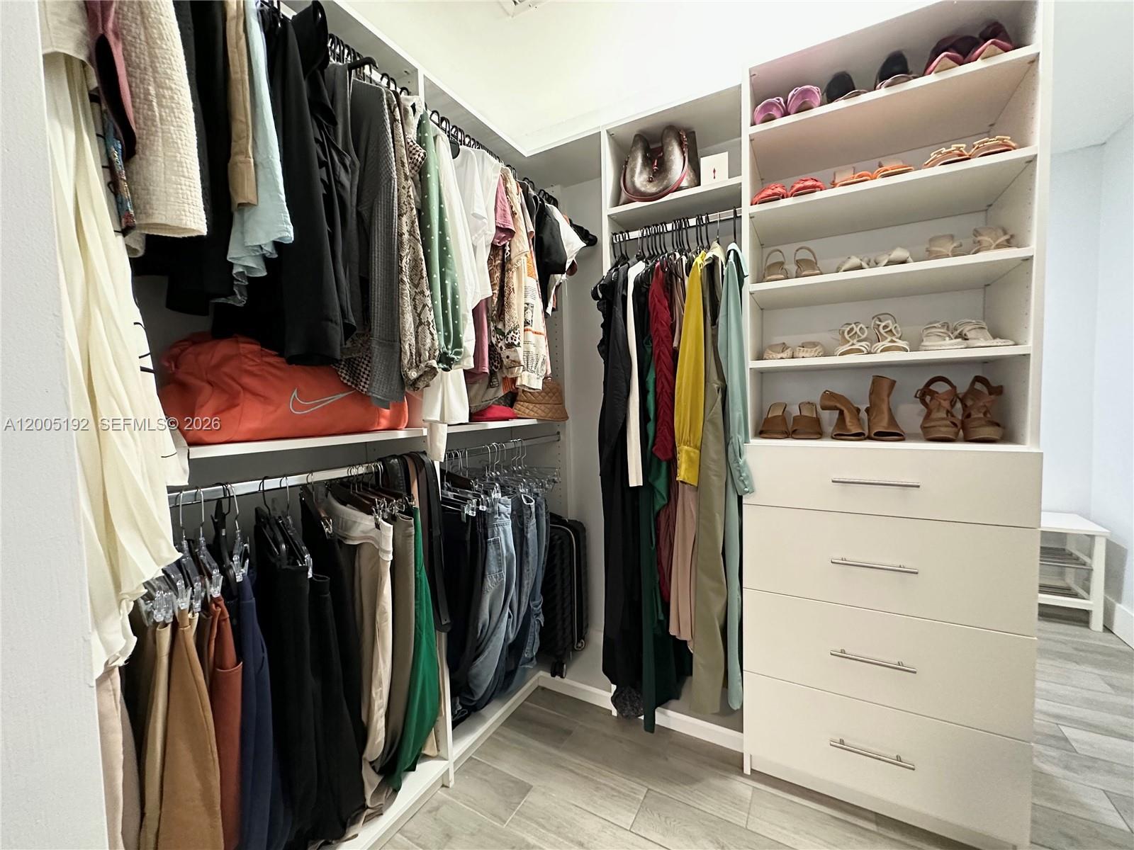4840 Southwest 149th Court, Unit 16F Miami, FL 33185 - Photo 20 of 33 a view of walk in closet with clothes and shoes