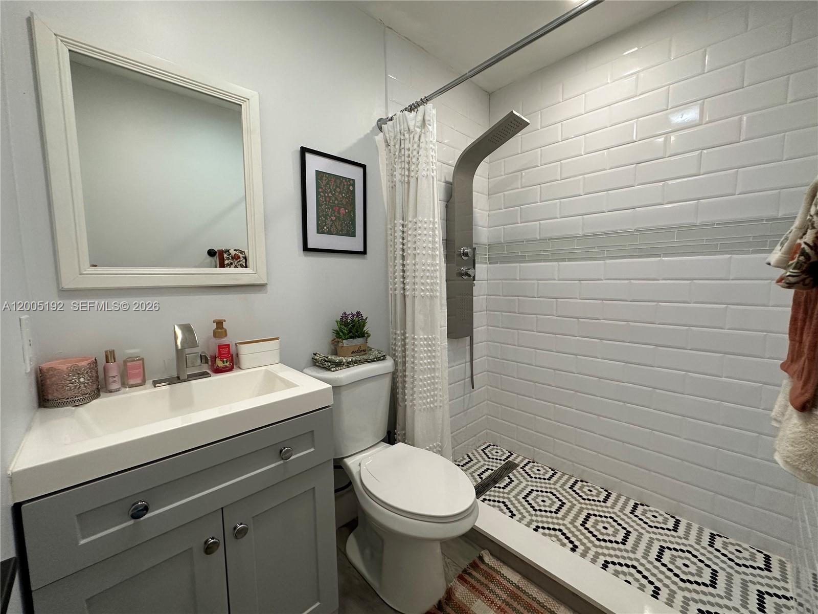 4840 Southwest 149th Court, Unit 16F Miami, FL 33185 - Photo 24 of 33 a bathroom with a toilet sink and mirror