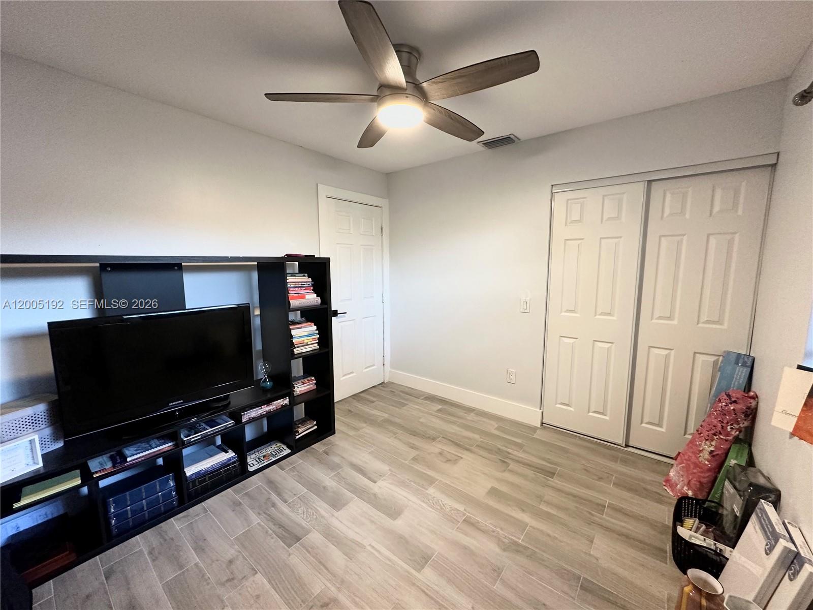 4840 Southwest 149th Court, Unit 16F Miami, FL 33185 - Photo 26 of 33 a living room with furniture and a flat screen tv