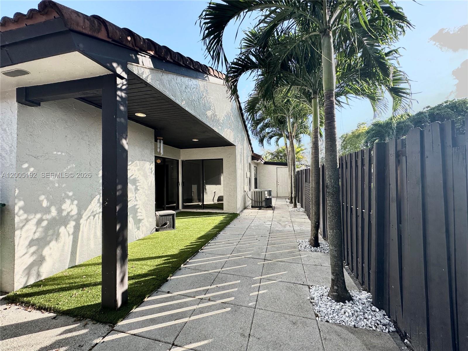 4840 Southwest 149th Court, Unit 16F Miami, FL 33185 - Photo 28 of 33 a view of a house with backyard porch and garden
