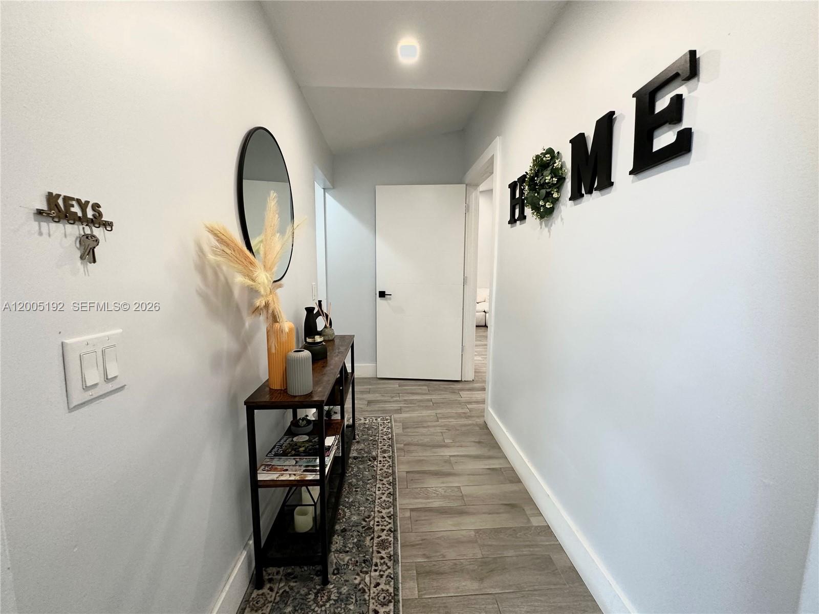 4840 Southwest 149th Court, Unit 16F Miami, FL 33185 - Photo 3 of 33 a view of a hallway with wooden floor and entryway