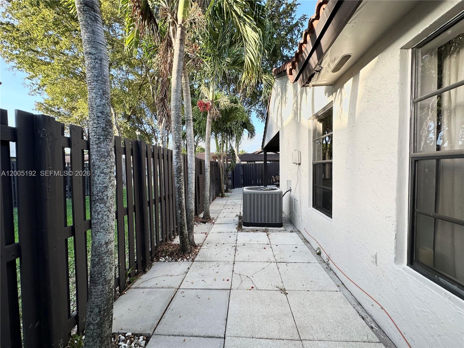 4840 Southwest 149th Court, Unit 16F Miami, FL 33185 - Photo 31 of 33 a view of a patio with table and chairs and potted plants