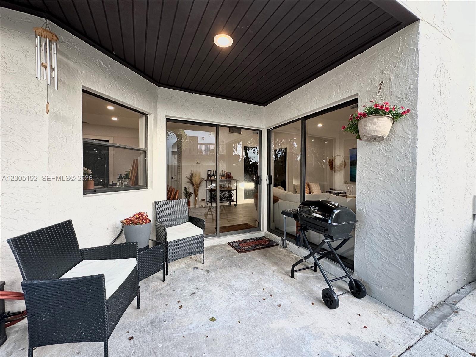 4840 Southwest 149th Court, Unit 16F Miami, FL 33185 - Photo 32 of 33 a view of a livingroom with workspace and a couch