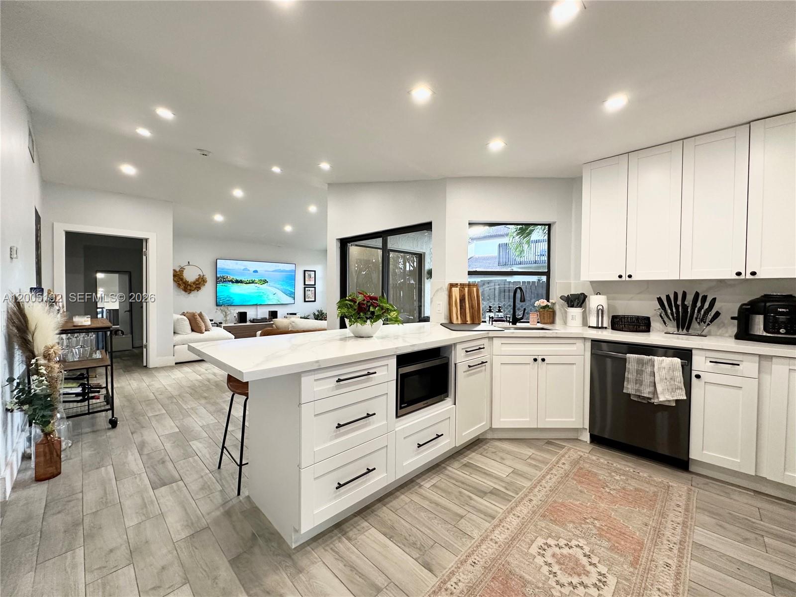 4840 Southwest 149th Court, Unit 16F Miami, FL 33185 - Photo 5 of 33 a kitchen with white cabinets and appliances