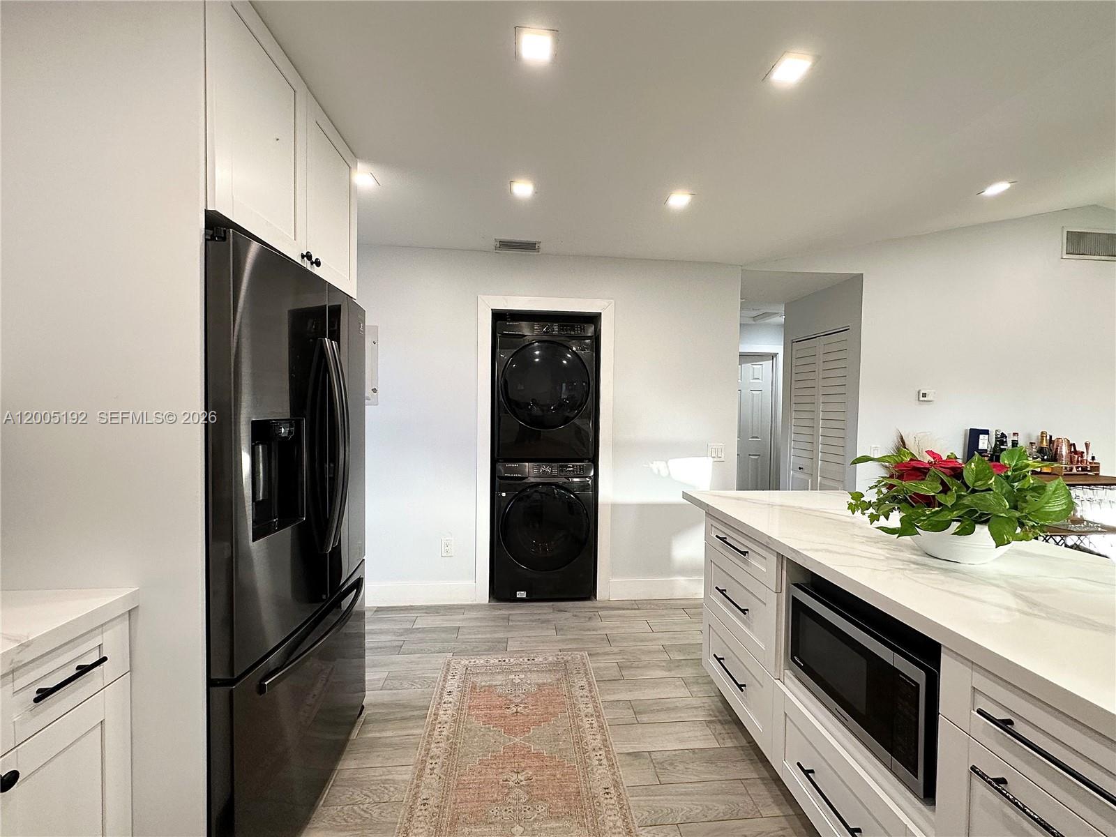 4840 Southwest 149th Court, Unit 16F Miami, FL 33185 - Photo 9 of 33 a kitchen with stainless steel appliances kitchen island granite countertop a refrigerator and a sink
