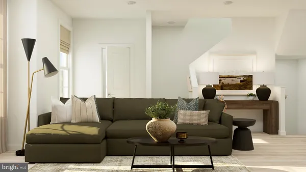 a living room with furniture and a lamp