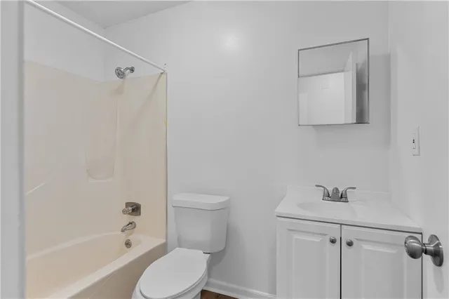 a white toilet sitting next to a bath tub