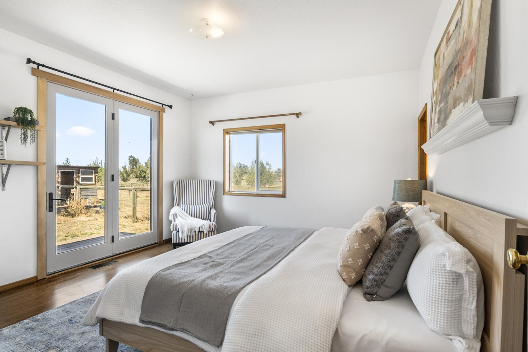 65515 Cline Falls Road Bend, OR 97703 - Photo 26 of 57 a bedroom with a large bed and a large window