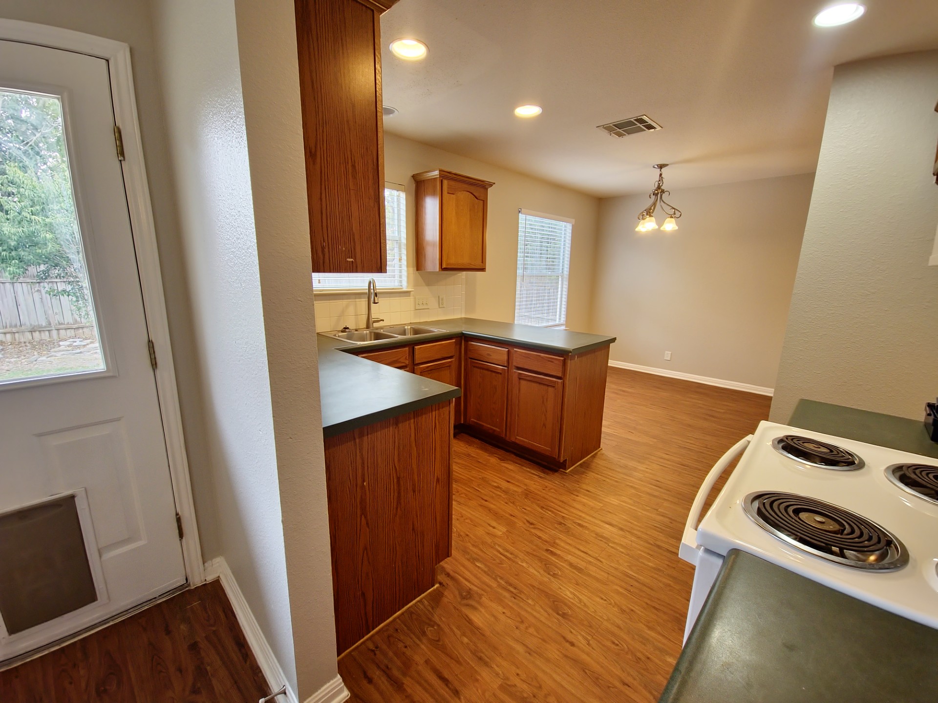 107 Orange Tree Lane Georgetown, TX 78626 - Photo 8 of 16 A functional kitchen with a practical layout, ready for your culinary adventures and daily living.