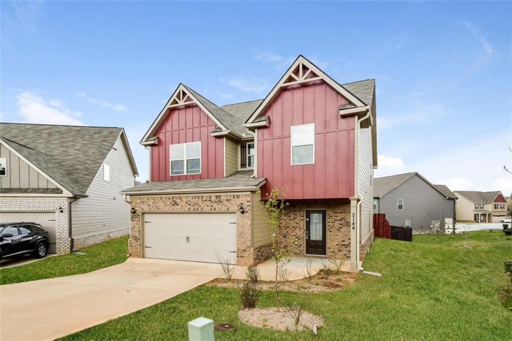a front view of a house with a yard and garage