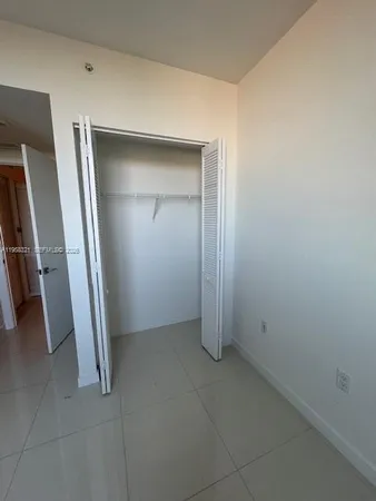 an empty room with an entrance to other room