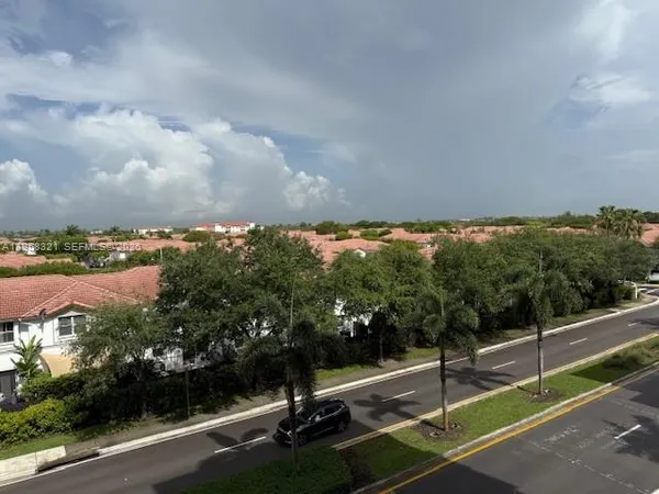 a view of a street with a building in the background