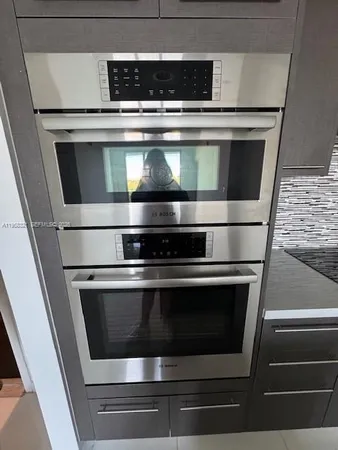 a stove top oven sitting inside of a kitchen
