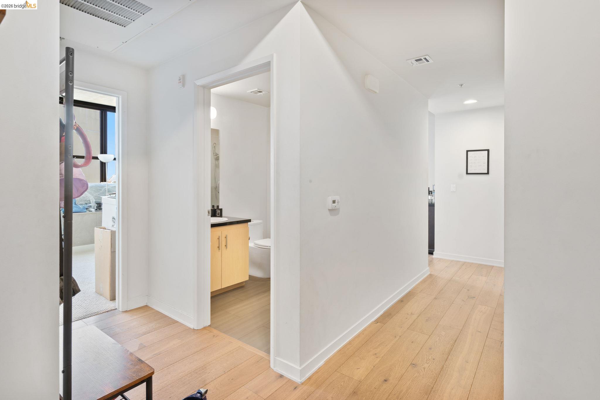 311 2nd Street, Unit 511 Oakland, CA 94607 - Photo 5 of 44 Hall featuring light wood-style floors and baseboards
