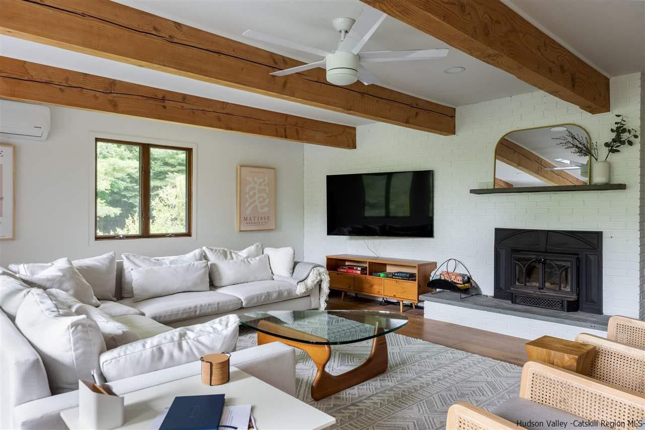 1882 County Road Olivebridge, NY 12461 - Photo 11 of 35 a living room with furniture a flat screen tv and a fireplace