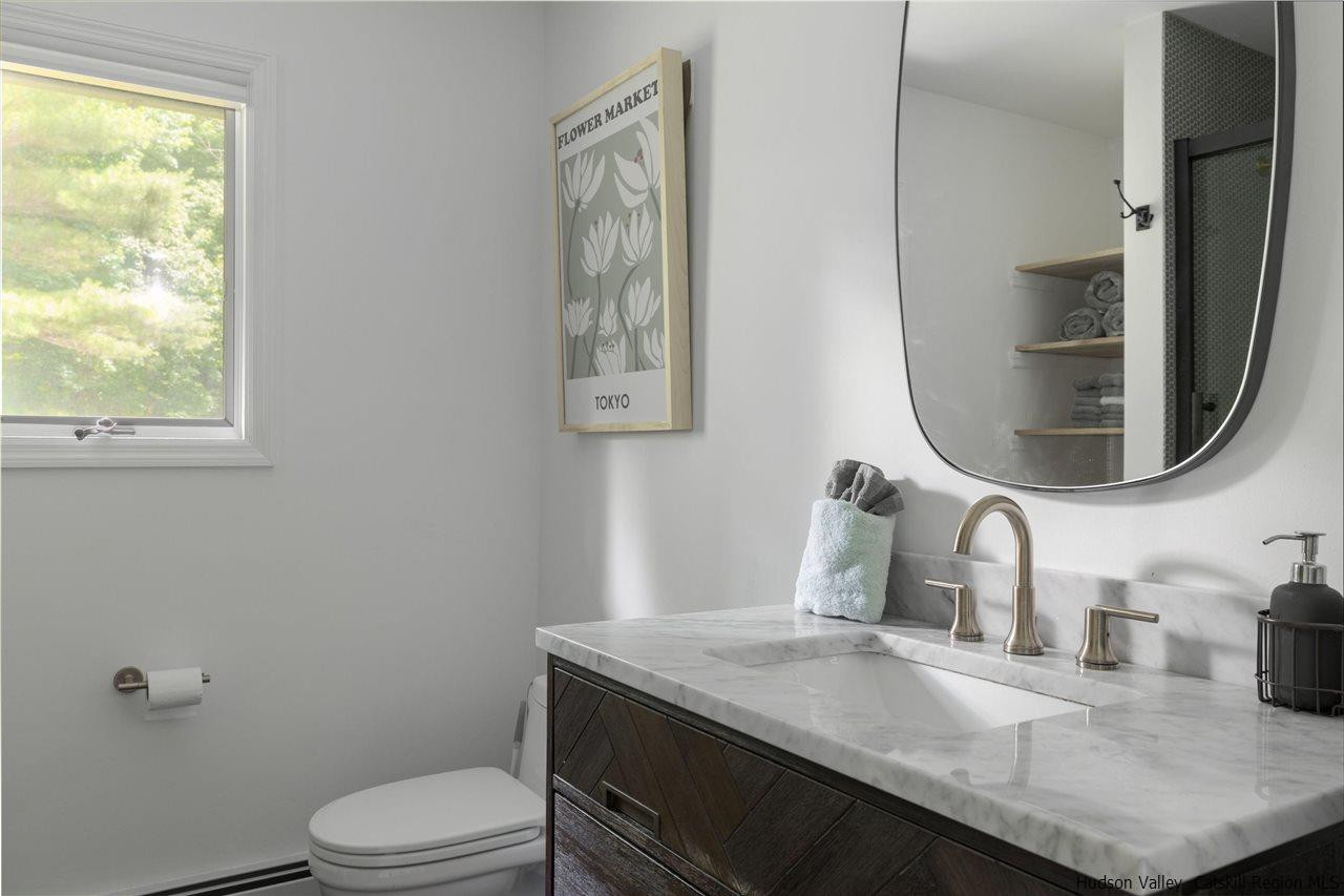 1882 County Road Olivebridge, NY 12461 - Photo 21 of 35 a bathroom with a granite countertop toilet sink and mirror