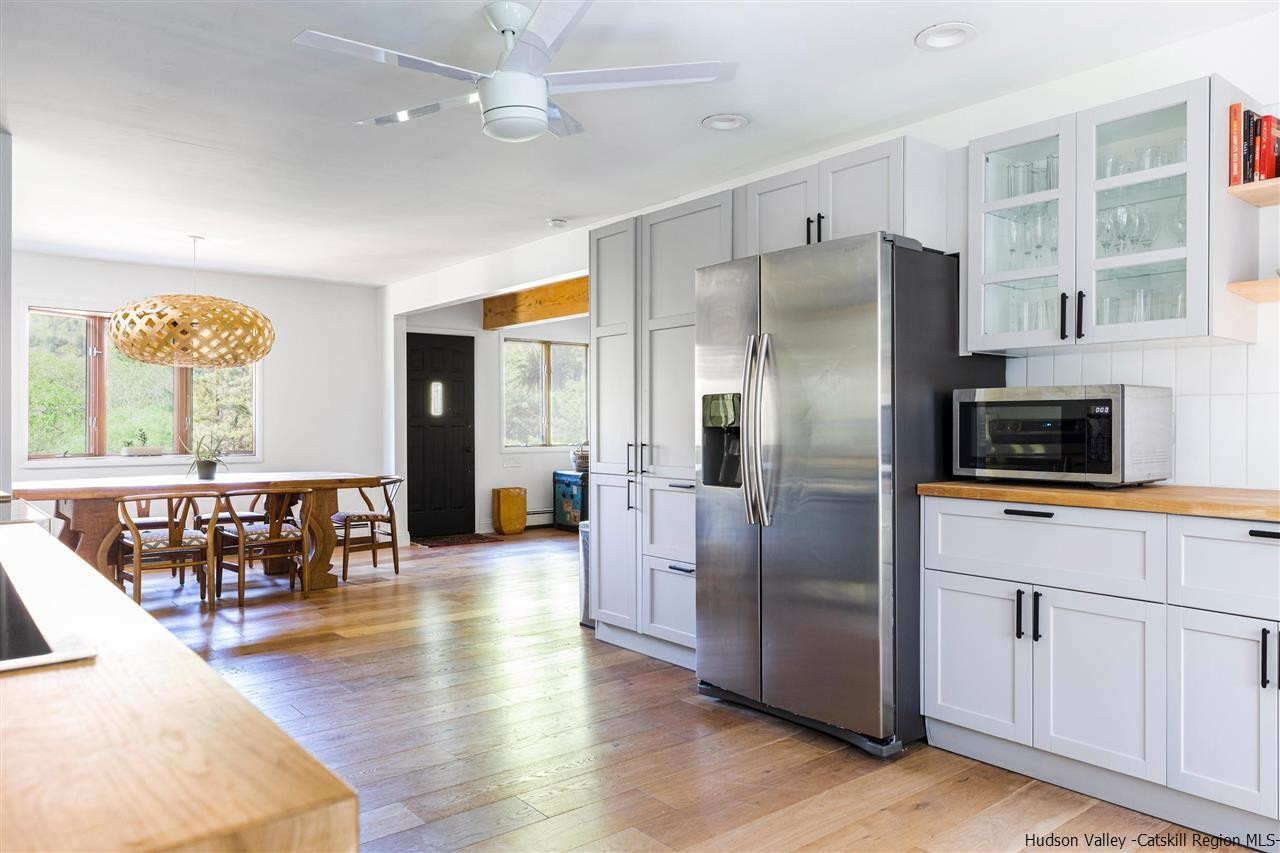 1882 County Road Olivebridge, NY 12461 - Photo 4 of 35 a kitchen with stainless steel appliances granite countertop a refrigerator a stove a microwave oven a sink with island and chairs