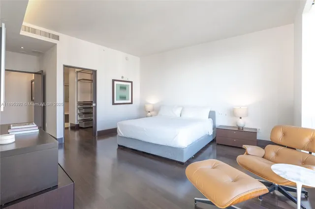 a bedroom with furniture and wooden floor