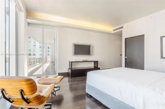 a bedroom with a bed and glass windows