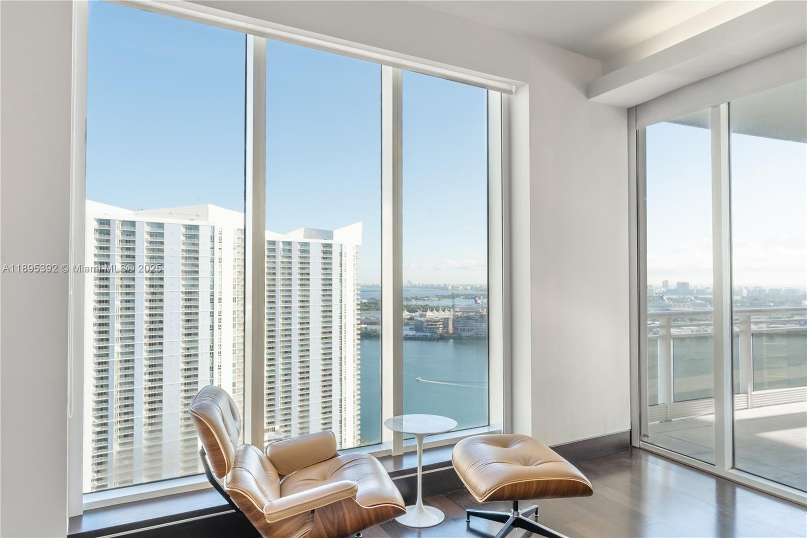 901 Brickell Key Boulevard, Unit 3607 Miami, FL 33131 - Photo 15 of 46 a living room with furniture and a floor to ceiling window