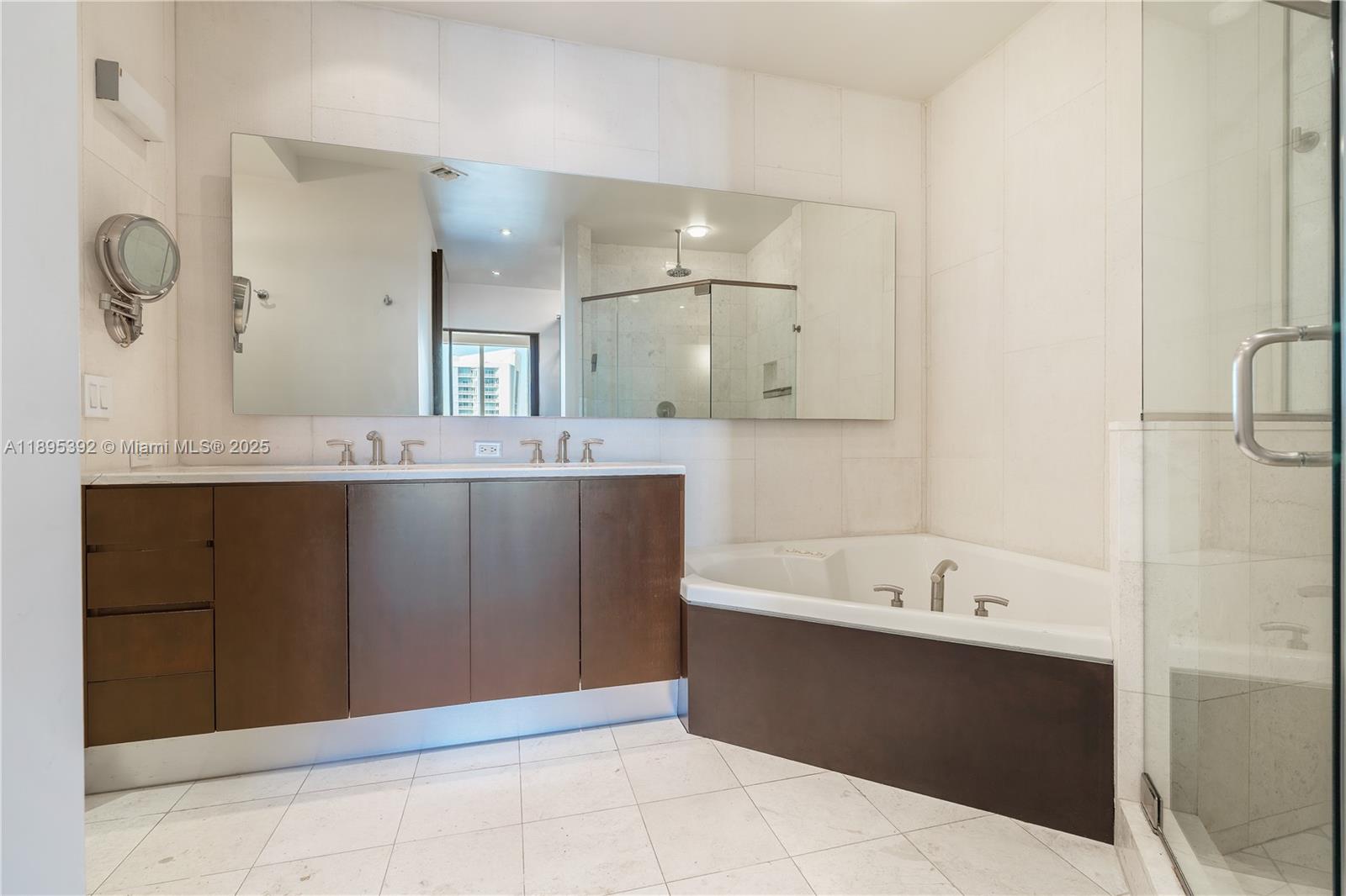 901 Brickell Key Boulevard, Unit 3607 Miami, FL 33131 - Photo 16 of 46 a bathroom with a tub sink and mirror