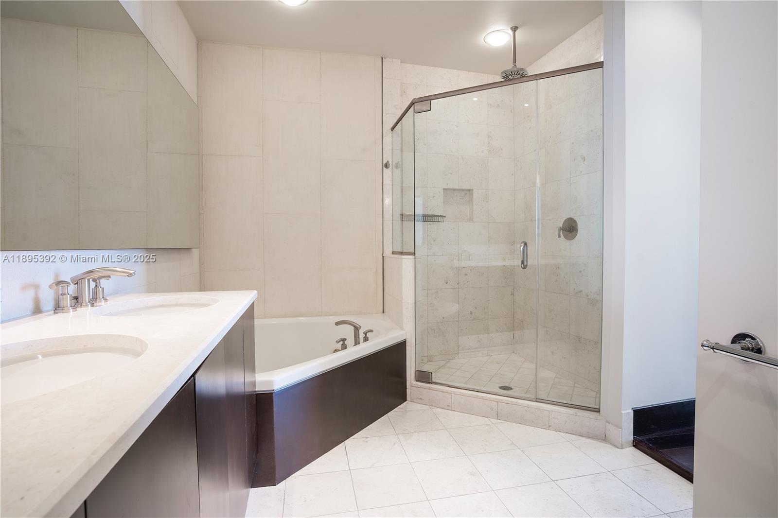 901 Brickell Key Boulevard, Unit 3607 Miami, FL 33131 - Photo 17 of 46 a bathroom with a tub sink shower and mirror