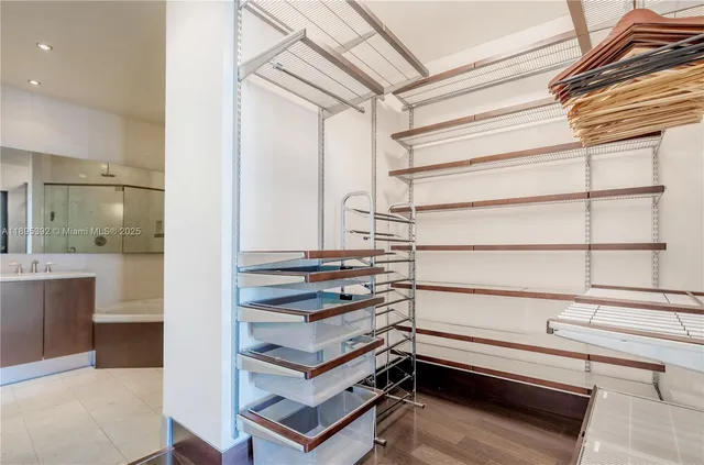 a view of walk in closet with empty racks
