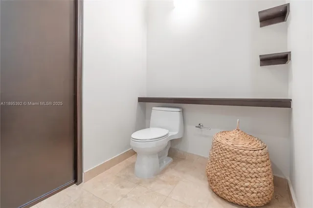 a bathroom with a toilet and a mirror