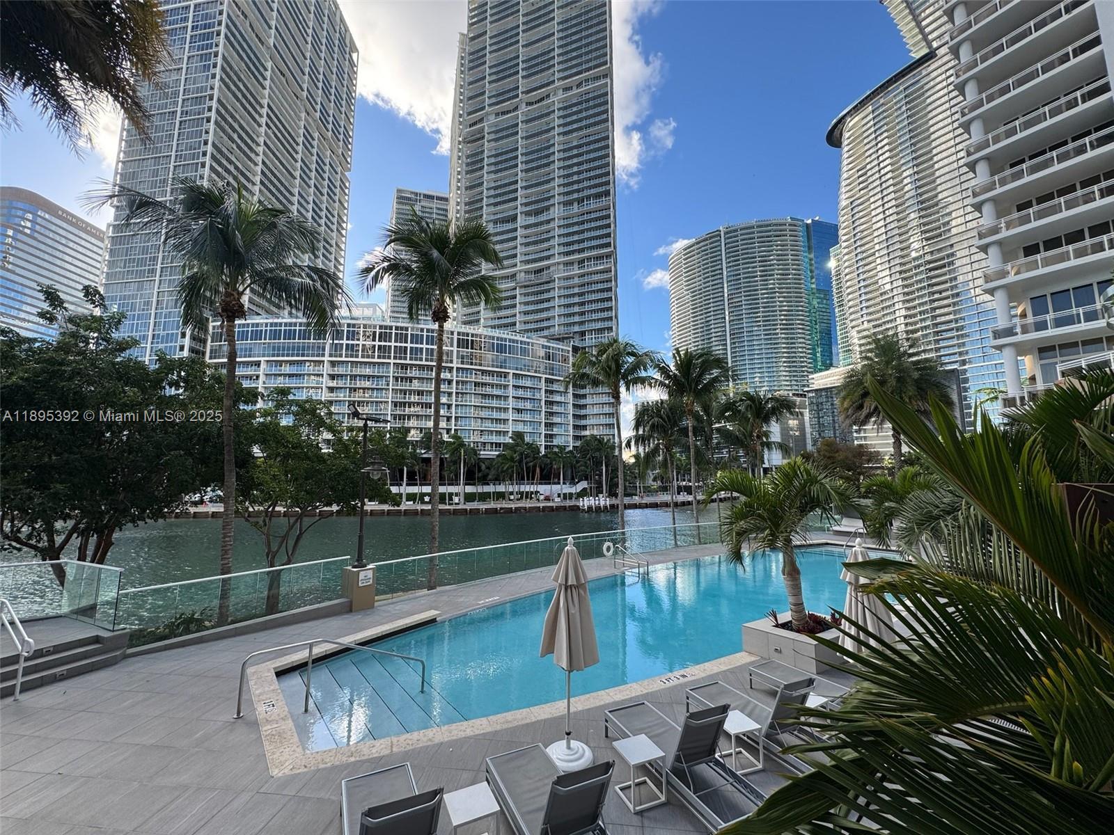 901 Brickell Key Boulevard, Unit 3607 Miami, FL 33131 - Photo 27 of 46 a view of swimming pool with outdoor seating