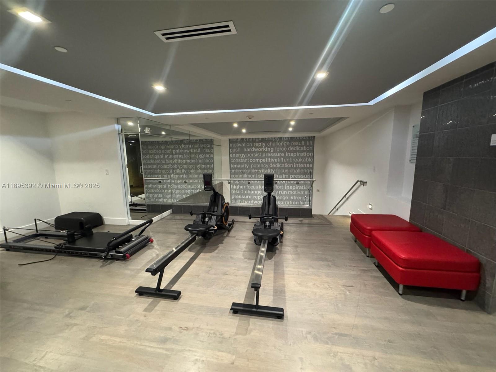901 Brickell Key Boulevard, Unit 3607 Miami, FL 33131 - Photo 32 of 46 a room with gym equipment and a table