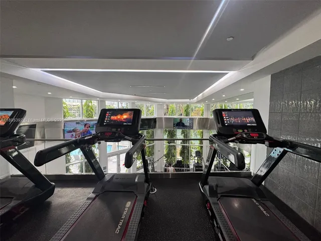 a room with gym equipment and a mirror