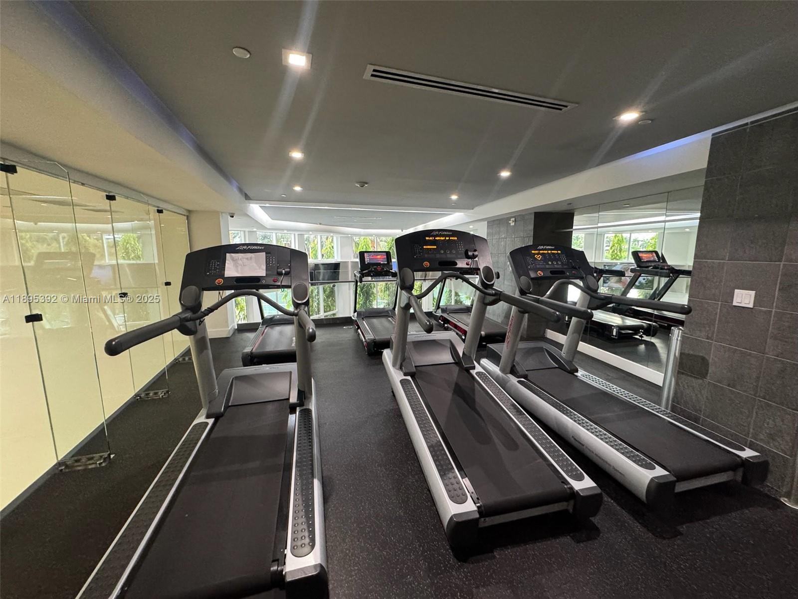 901 Brickell Key Boulevard, Unit 3607 Miami, FL 33131 - Photo 35 of 46 a view of a room with gym equipment