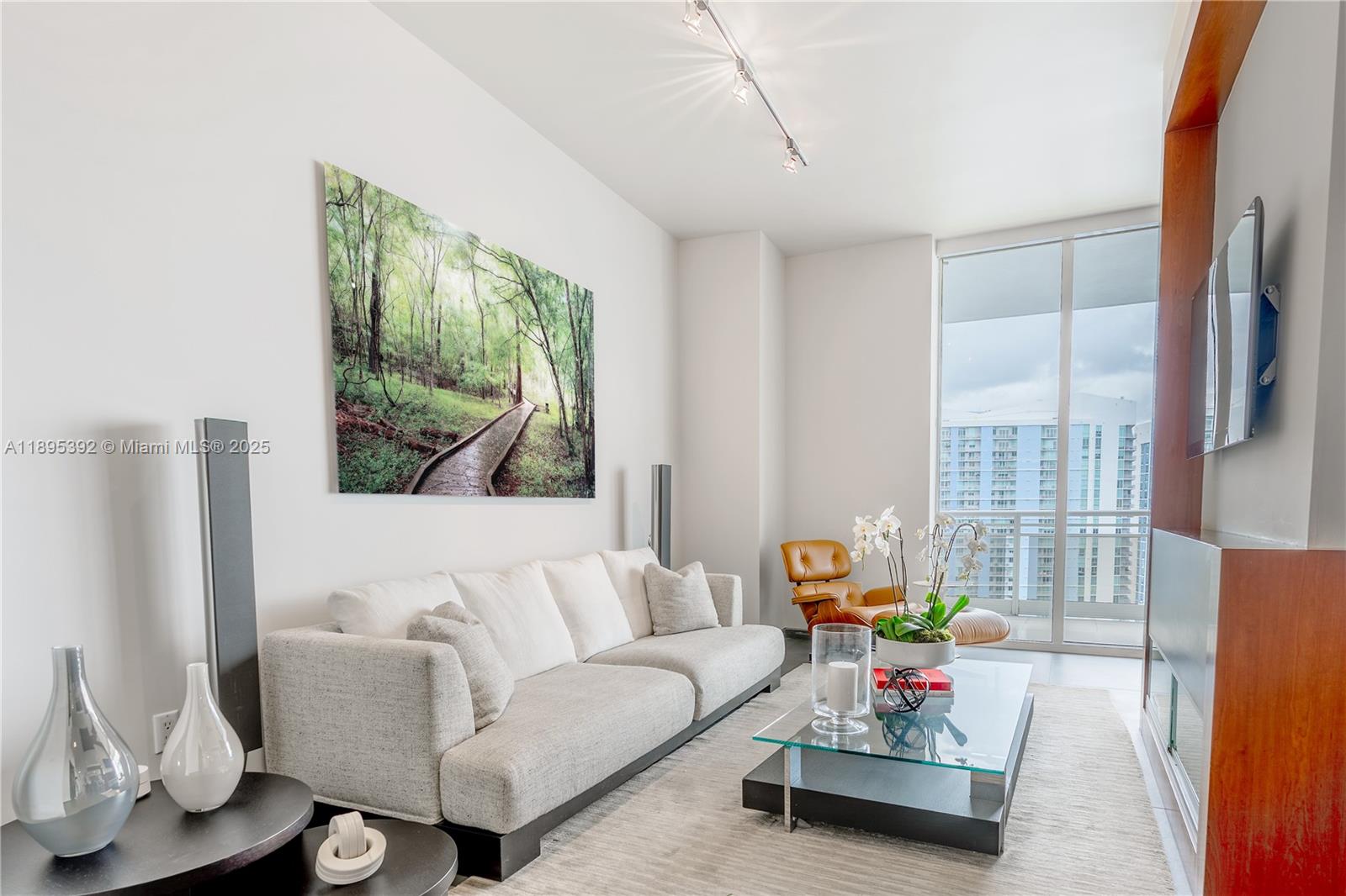 901 Brickell Key Boulevard, Unit 3607 Miami, FL 33131 - Photo 4 of 46 a living room with furniture and a flat screen tv