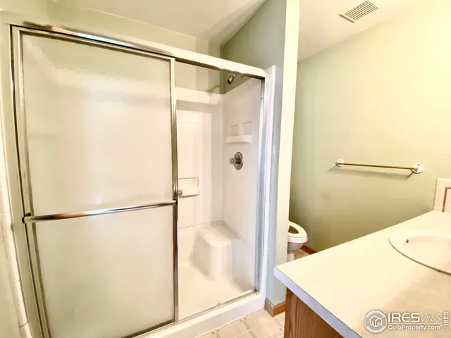 a bathroom with a glass shower door