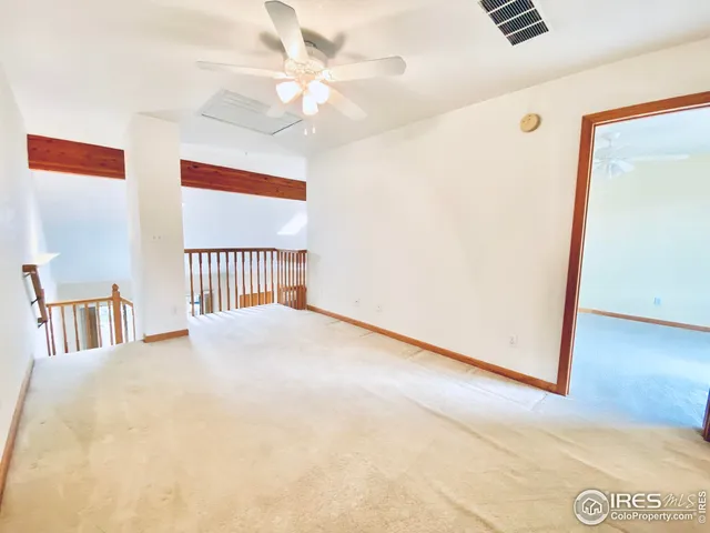 a view of a room with a ceiling fan
